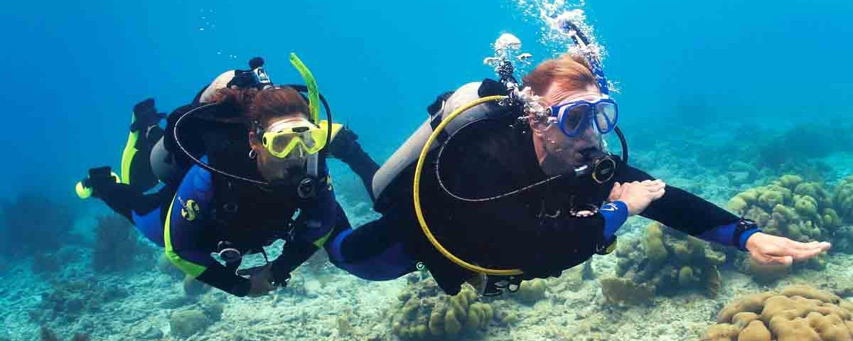 two scuba divers navigating underwater